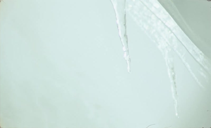 Icicles hang from a the ceiling of a frozen cave