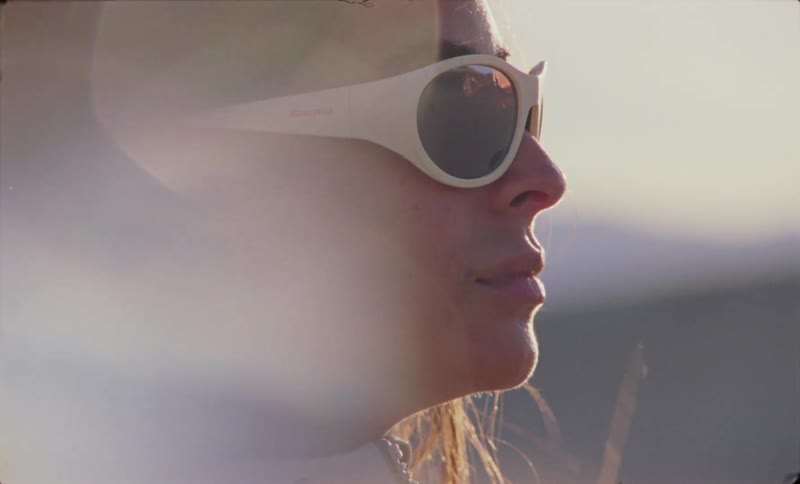 Side portrait of a woman with sunglasses in a desert setting