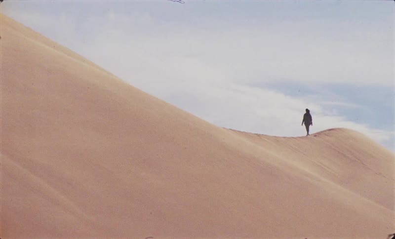 Person walking on a desert dune
