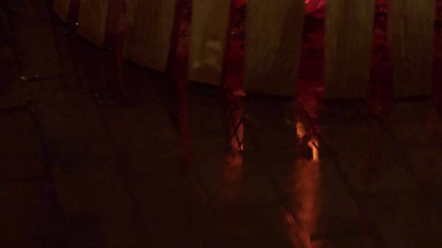 Flames burn inside of holes and create a reflection within a structure
