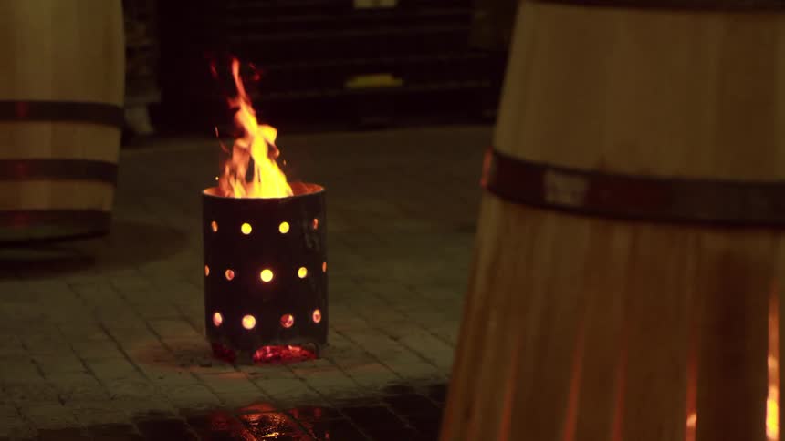 Wooden barrels being charred a step in the whiskymaking process