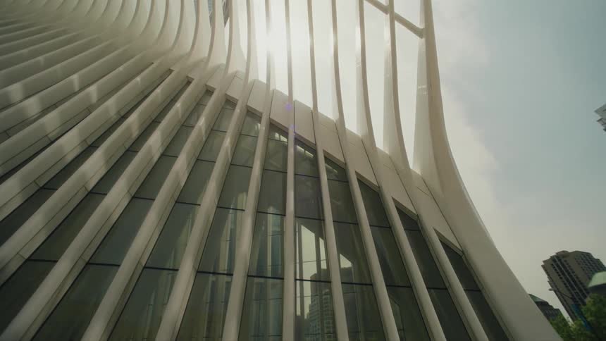 The facade of a building with a structure of white beams and glass windows