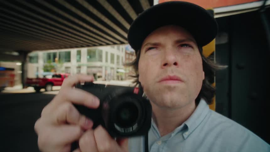 Portrait of a photographer using a professional camera