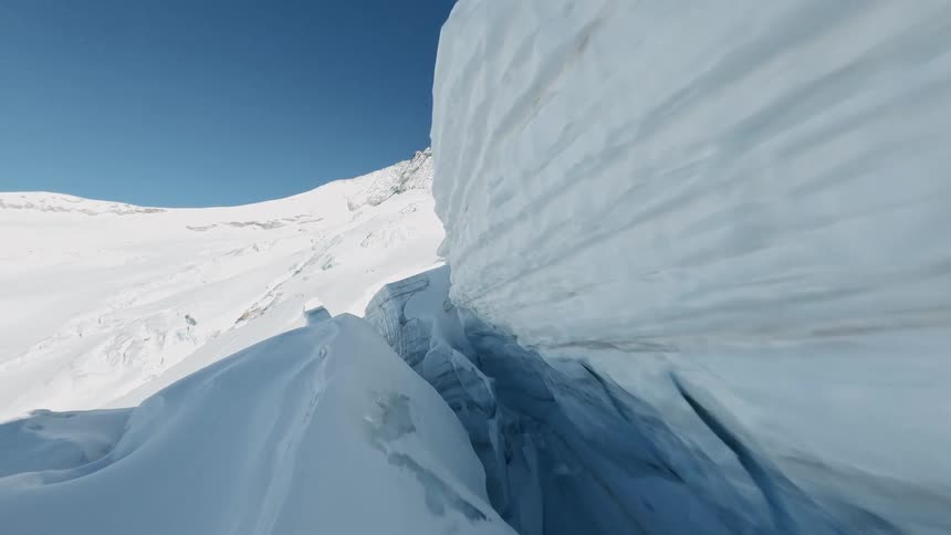 Aerial View Flying Through a Large Ice Crevasse in a Swiss Glacier