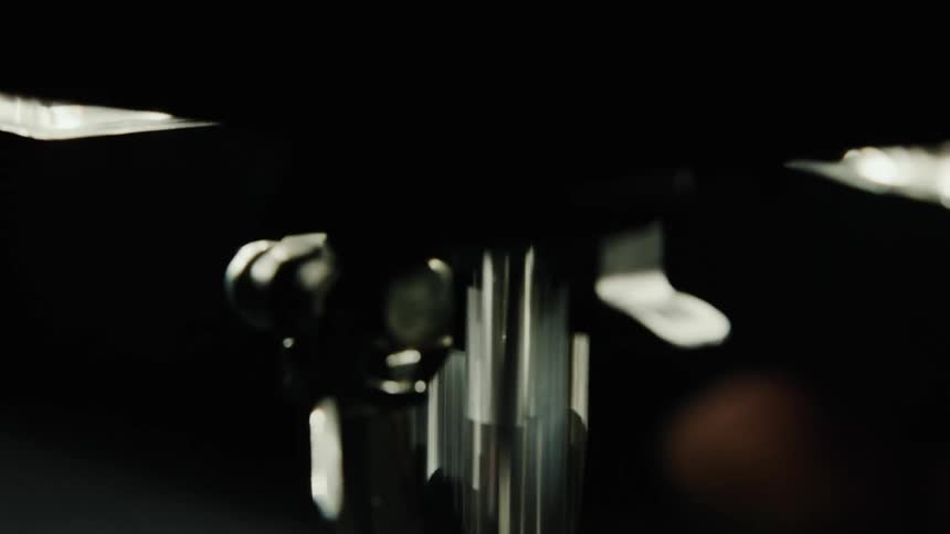 Close up of a needle of a sewing machine in operation