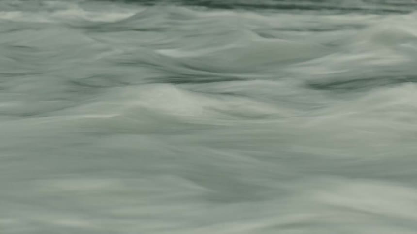 Rapidly flowing river water forms small waves