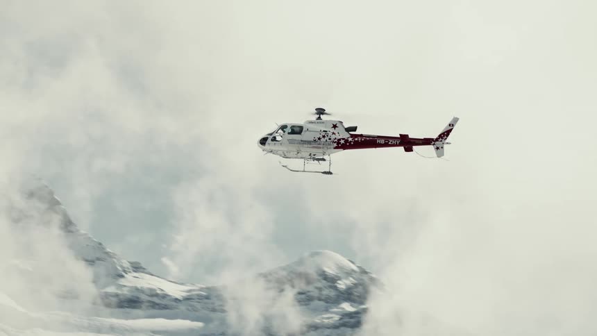 A clip of an helicopter flying up in the mountains