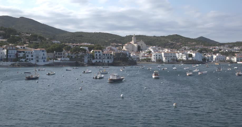 Aerial landscape of the sea with boats and in the background an urban city in the mountains