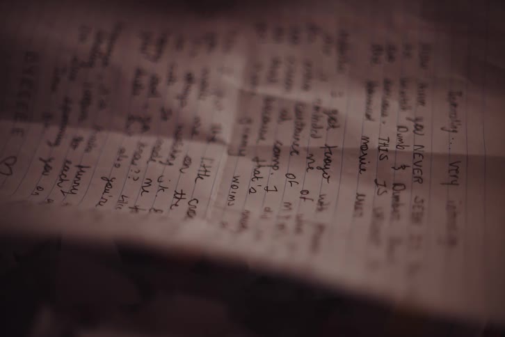 A clip of a person placing a picture on a writing letter
