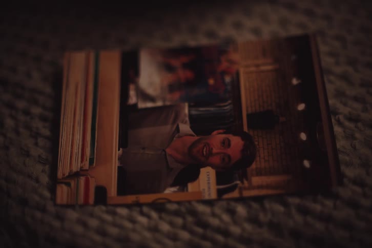 A person places a photograph of a man and then of a woman a warm smile