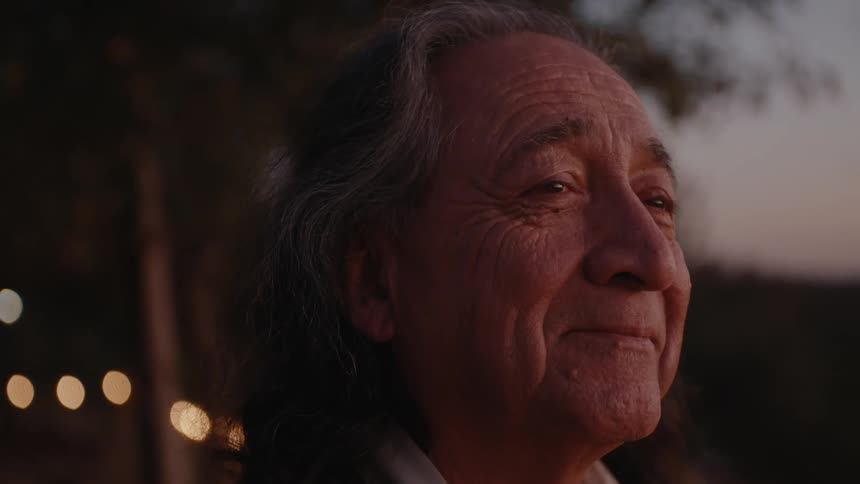 Native American elder takes in the sunset at dusk