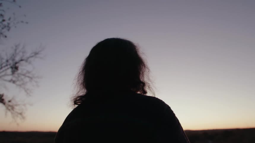 A clip of an elderly man looking at the sky