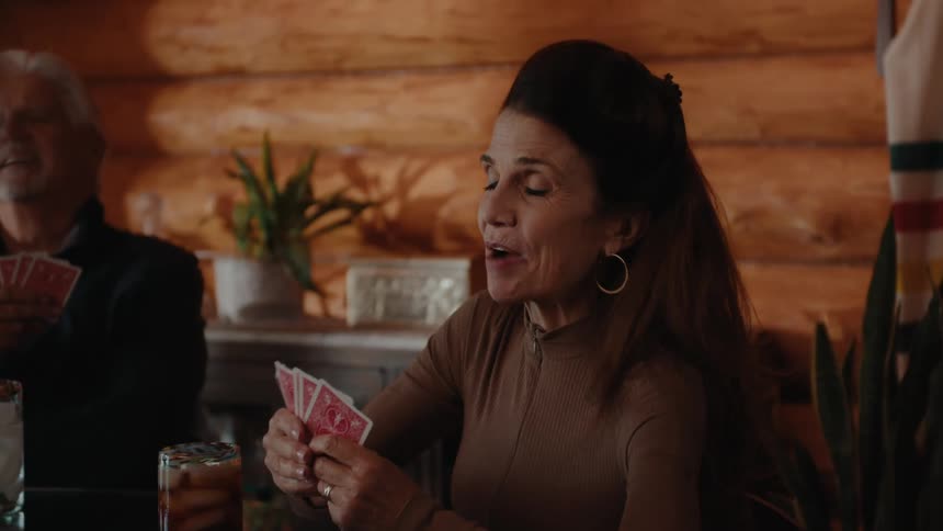People sitting at a table playing a card game