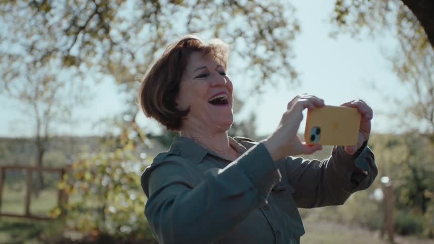 Woman holding an iphone and taking a picture