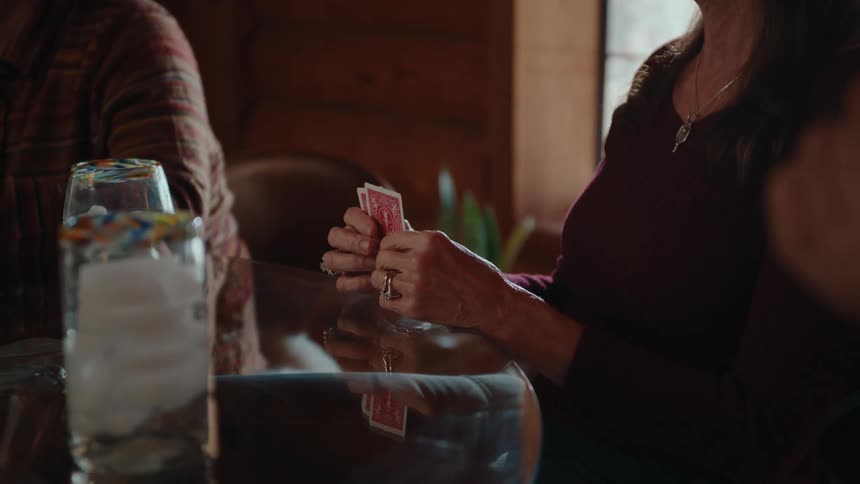 A woman playing cards with friends at home