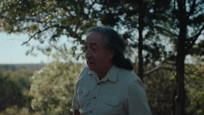 Elderly man outdoors throwing an object and vibrating