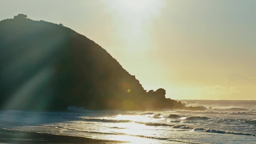 Landscape of a beach with the sunrise on the horizon