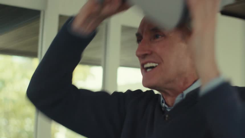 A person is using a virtual reality headset inside a modern welllit room with large windows