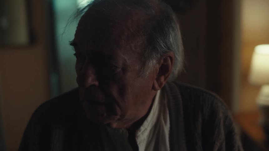 Portrait of a dejected elderly man walking towards a door
