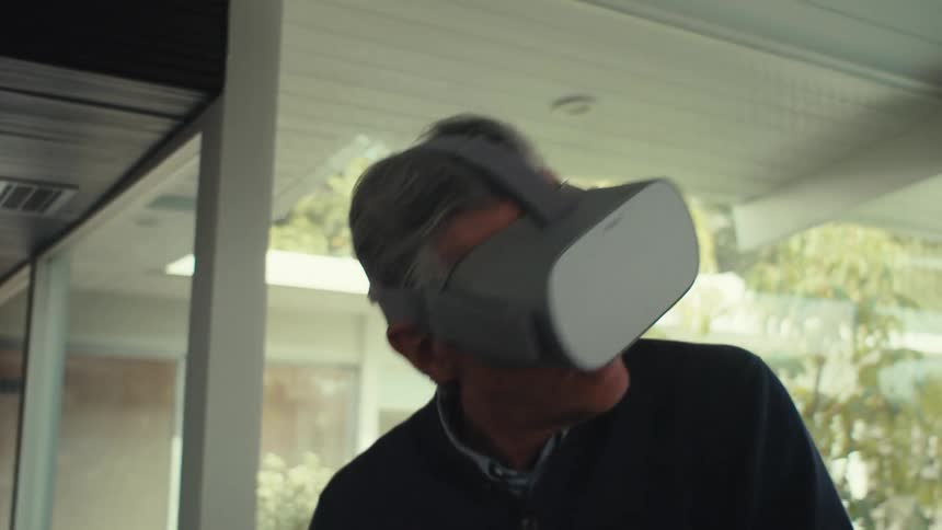 Man putting on virtual reality glasses and playing