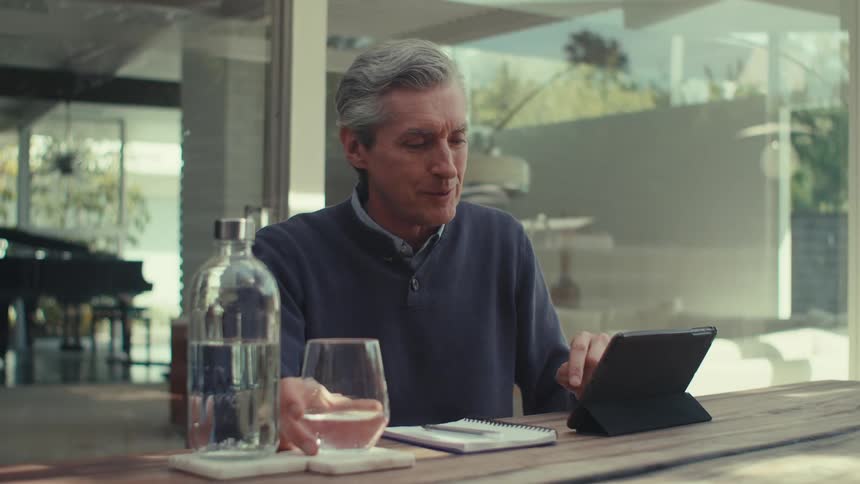 A clip of a man presenting a conversation on a phone