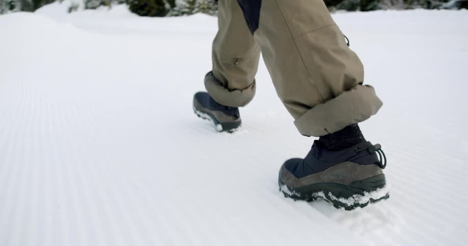 A clip of a person walking on the snow