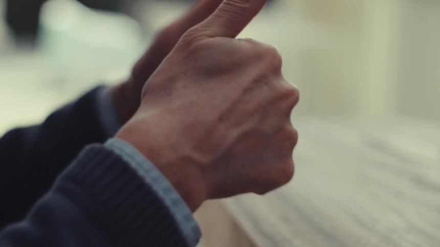 Man gives double thumbs up during a video call