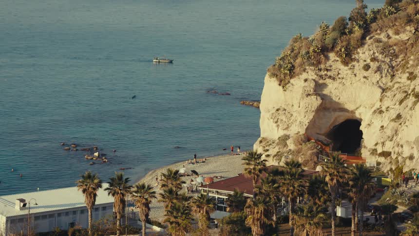 Landscape of a beach with a rocky coast and bathers