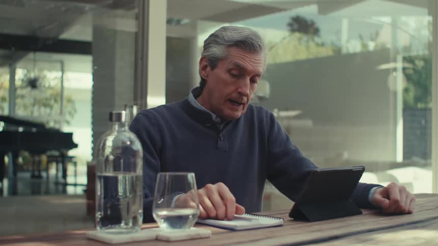 A clip of a man having a phone conversation on a tablet