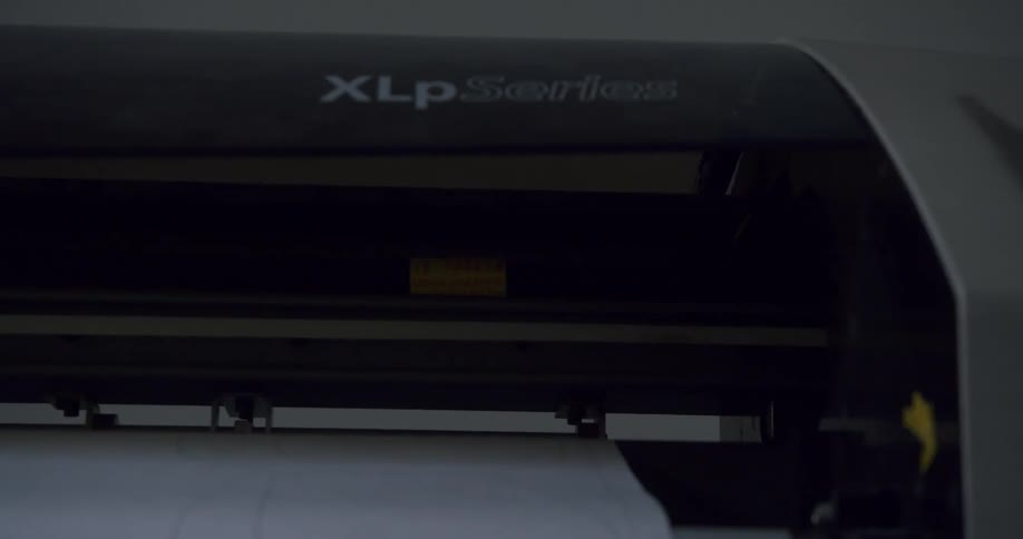 A printer is printing on a long sheet of paper