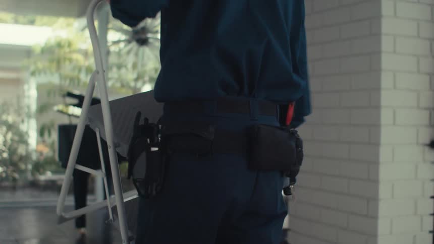 A clip of a man walking with a chair in the house