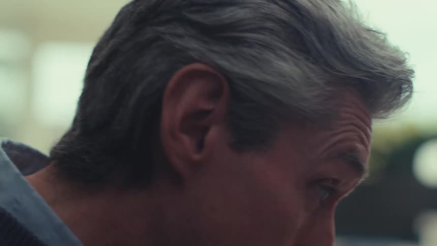 Closeup of an older man smiling and talking during a video call