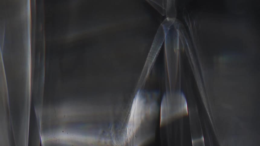 An abstract object seen very close up with a texture with several cavities and a reflected silver color