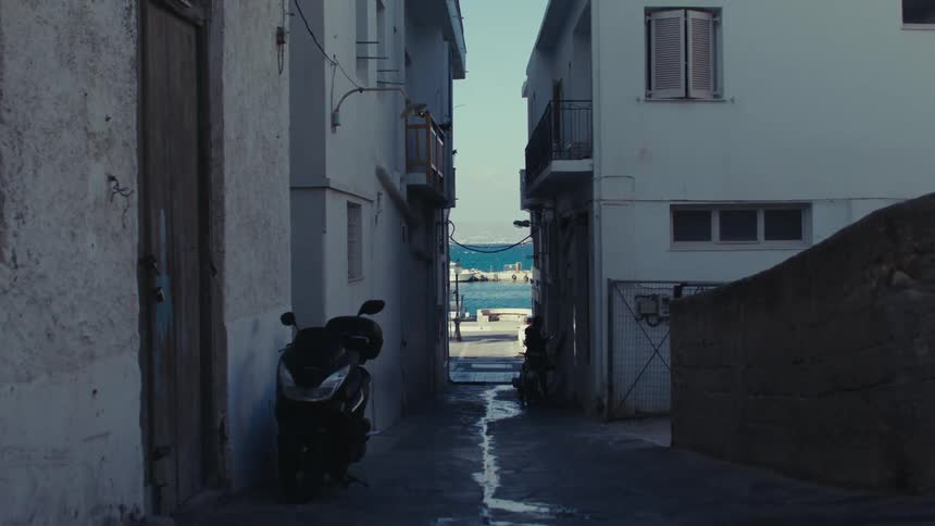 A couple cyclist pass by an alley