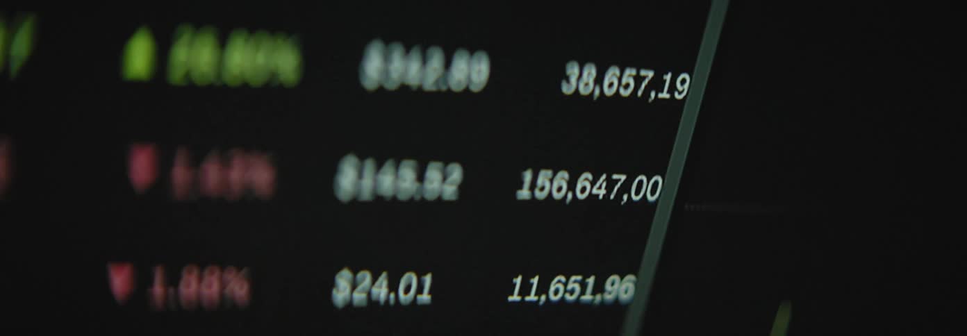 Thats a close up shot of a stock ticker or financial data display showing fluctuating numbers and possibly candlestick charts