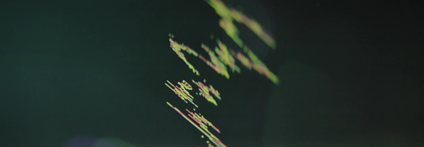 Closeup of a graph of financial data that occasionally shows spots of light