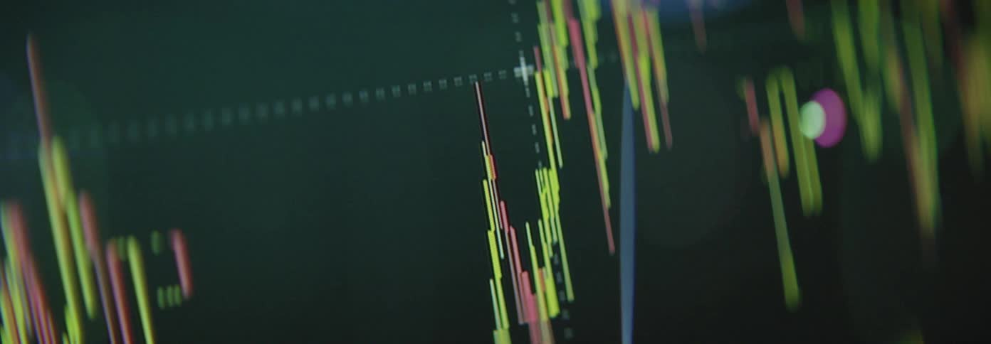 A financial chart displaying colorful candlestick patterns indicates market trends and price movements