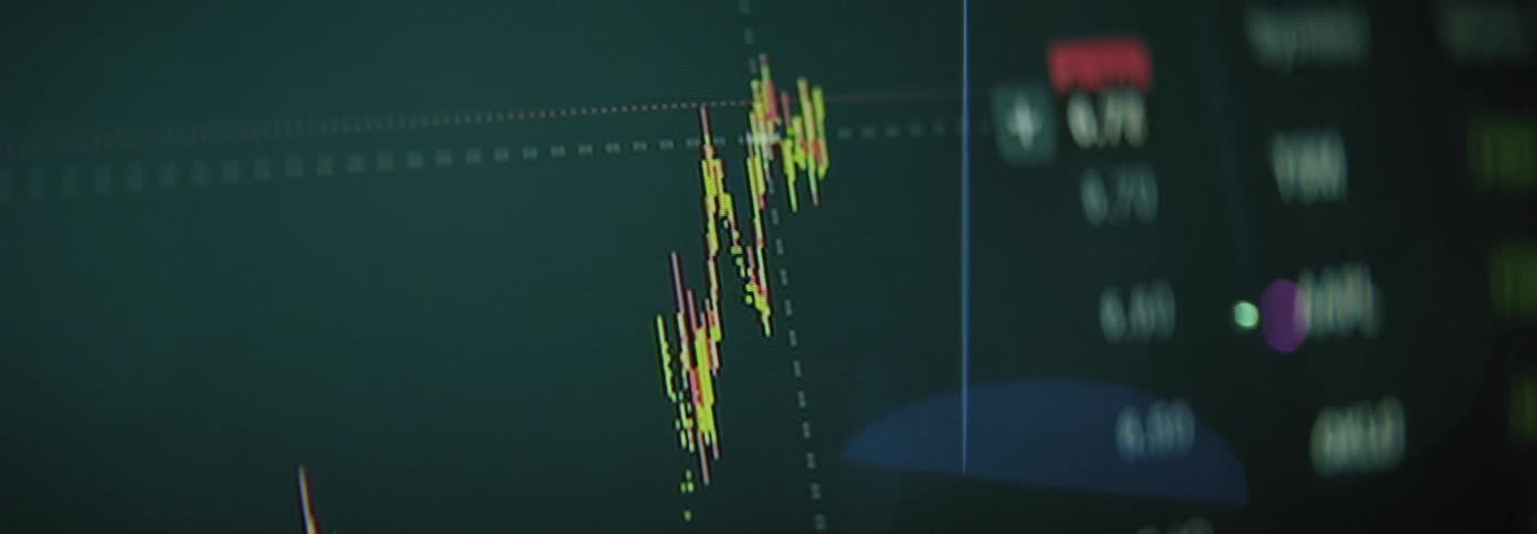 The monitor is showing stock activity