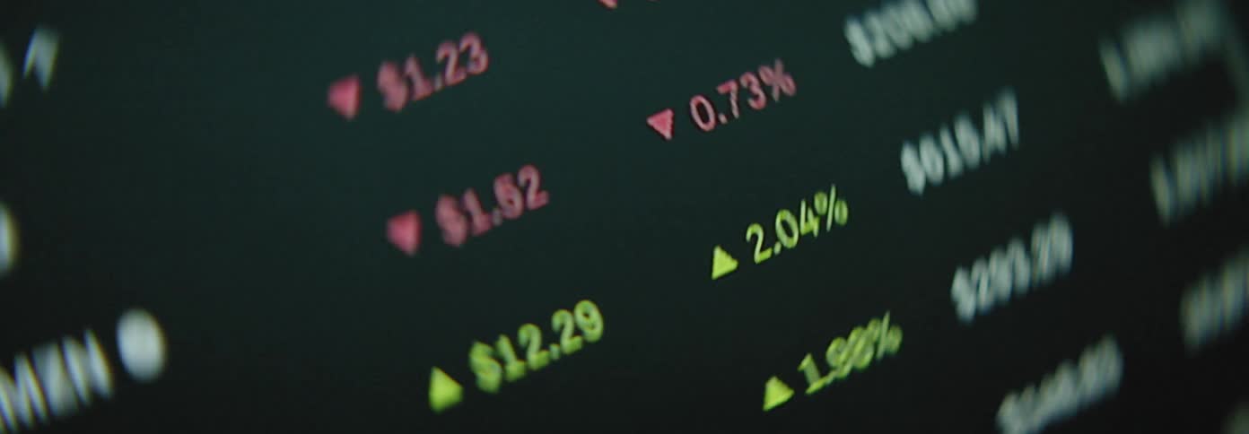 A closeup view of a stock market ticker displaying various stock symbols prices and percentage changes