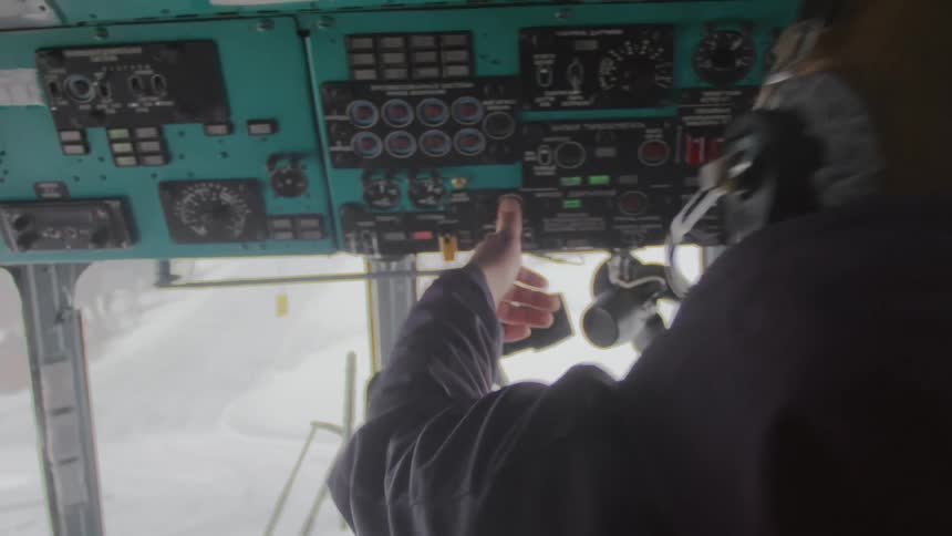 Man in the cockpit of an airplane operating