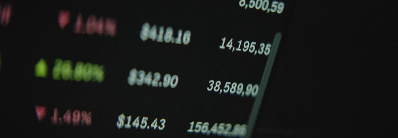 A closeup view of a stock market ticker displaying various stock symbols prices and percentage changes