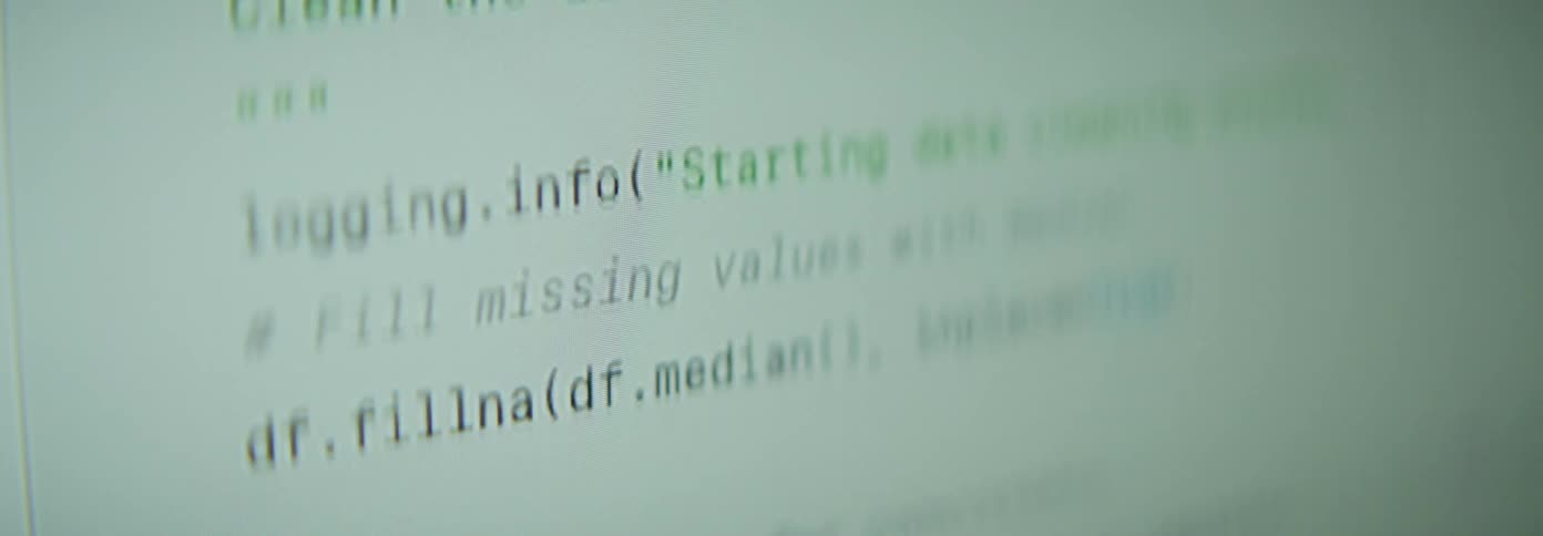 Computer code scrolls upward on a monitor