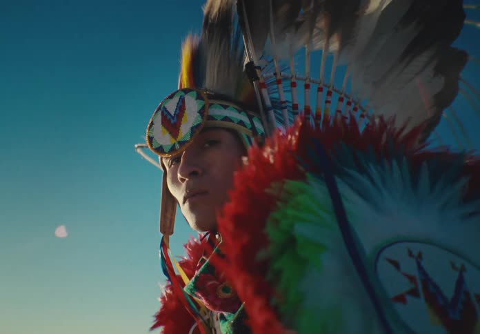 Portrait of a young man in native american costume
