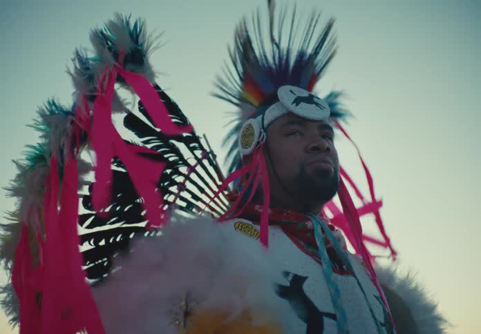Native american man dressed in tribal attire outdoors