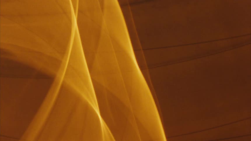Close up of a warm yellow light in abstract motion against a dark background