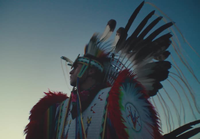 Man wearing traditional native american feather clothing