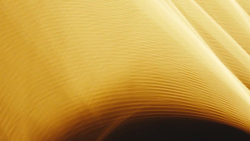 A glowing streak of golden light captured in an abstract artistic style