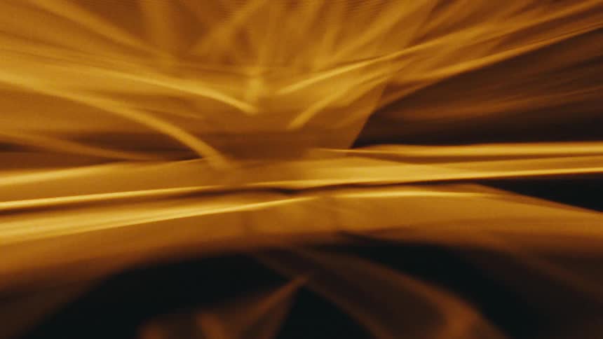 Abstract reflection of warm yellow light on a dark background