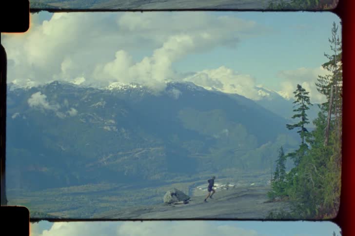 Man running down a mountain during the day