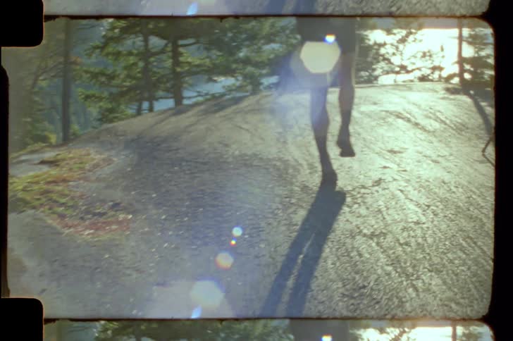 Legs of a person running on a rock in a natural environment